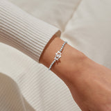 Joma Jewellery stretch beaded silver plated bracelet with intertwined star charm presented on blush pink foil stamped card.