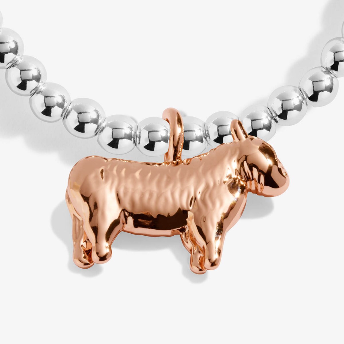 Joma jewellery stretch beaded bracelet with rose gold hanging highland cow charm.