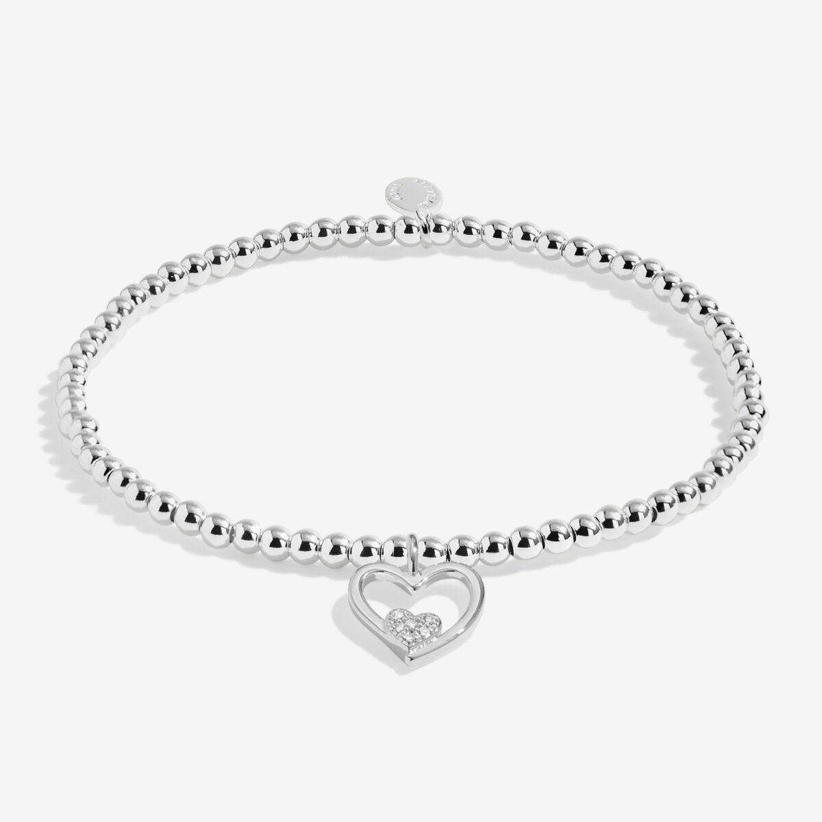 Joma jewellery stretch beaded bracelet with hanging heart charm with small sparkling heart presented on a foil stamped sentiment card.