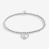 Joma jewellery stretch beaded bracelet with hanging heart charm with small sparkling heart presented on a foil stamped sentiment card.