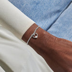 Joma jewellery stretch beaded bracelet with hanging heart charm with small sparkling heart presented on a foil stamped sentiment card.