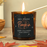 Personalised amber glass candle with pumpkin design.