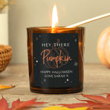 Personalised amber glass candle with pumpkin design.