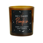 Personalised amber glass candle with pumpkin design.