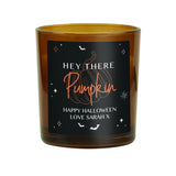 Personalised amber glass candle with pumpkin design.