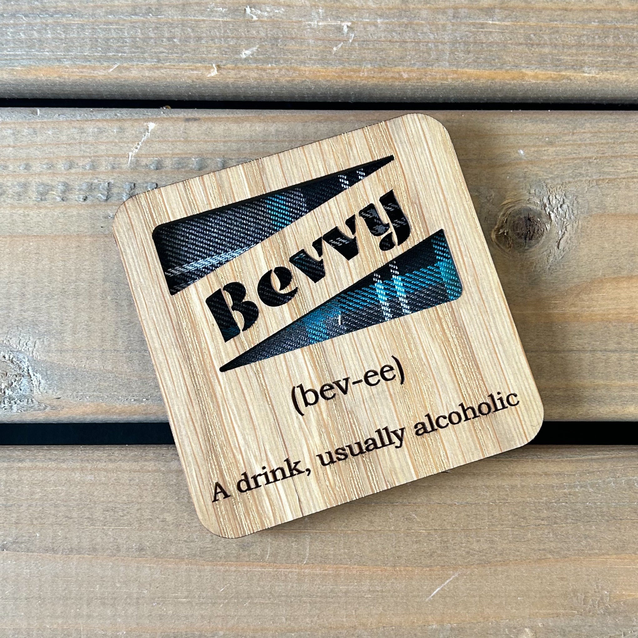 Oak veneer coaster with tartan insert and cut out wording 'Bevvy' with engraved definition.