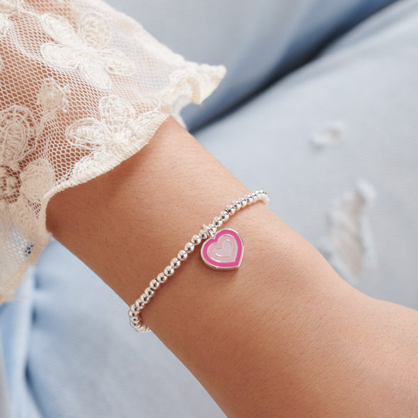 Children's silver beaded bracelet with pink heart charm