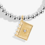 Joma girls beaded bracelet with gold plated book charm