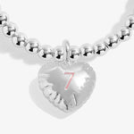 Joma jewellery girls silver plated beaded birthday bracelet with a hanging heart charm with a number 7 stamped in pink.