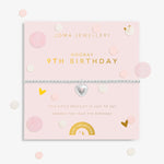 Joma girls birthday bracelet with silver plated beads and a hanging heart charm with '9' stamped in pink.