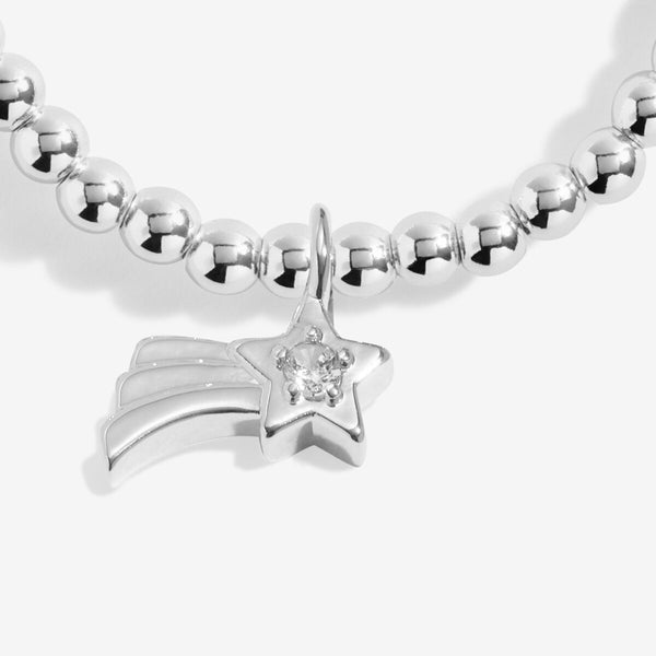 Joma Jewellery Girls Make A Christmas Wish beaded bracelet with shooting star charm presented on festive sentiment card.