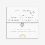 Silver plated girls Joma stretch bracelet with hanging heart charm presented on gifting card for Holy Communion
