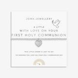 Silver plated girls Joma stretch bracelet with hanging heart charm presented on gifting card for Holy Communion