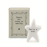 White porcelain star with the words 'You're a star' in black inside a matchbox with decorative black design and the wording 'Thanks for being amazing'.