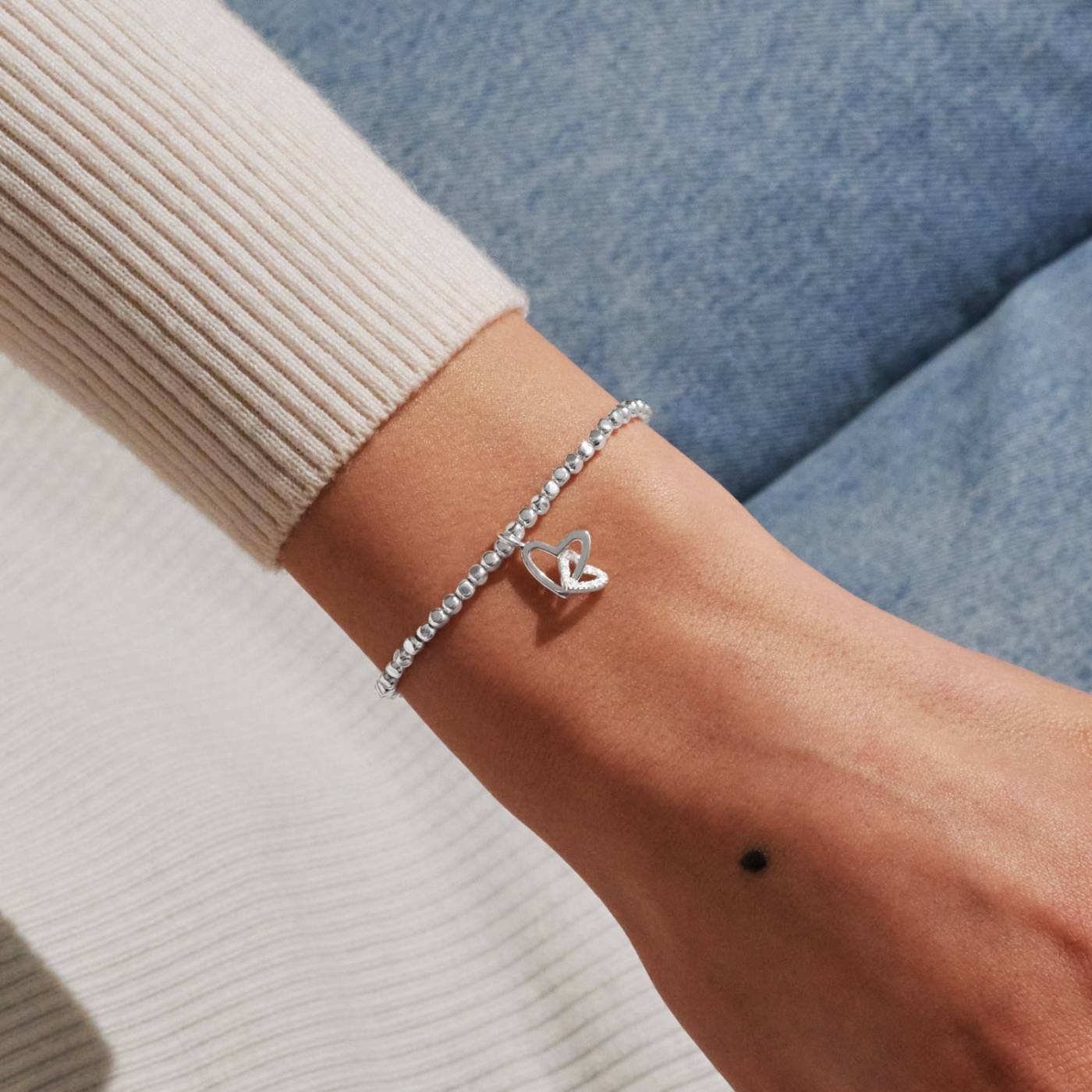 Silver bracelet with two hearts linked