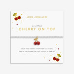Joma jewellery stretch beaded silver plated bracelet with red cherry charm presented on a sentiment card.