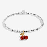 Joma jewellery stretch beaded silver plated bracelet with red cherry charm presented on a sentiment card.