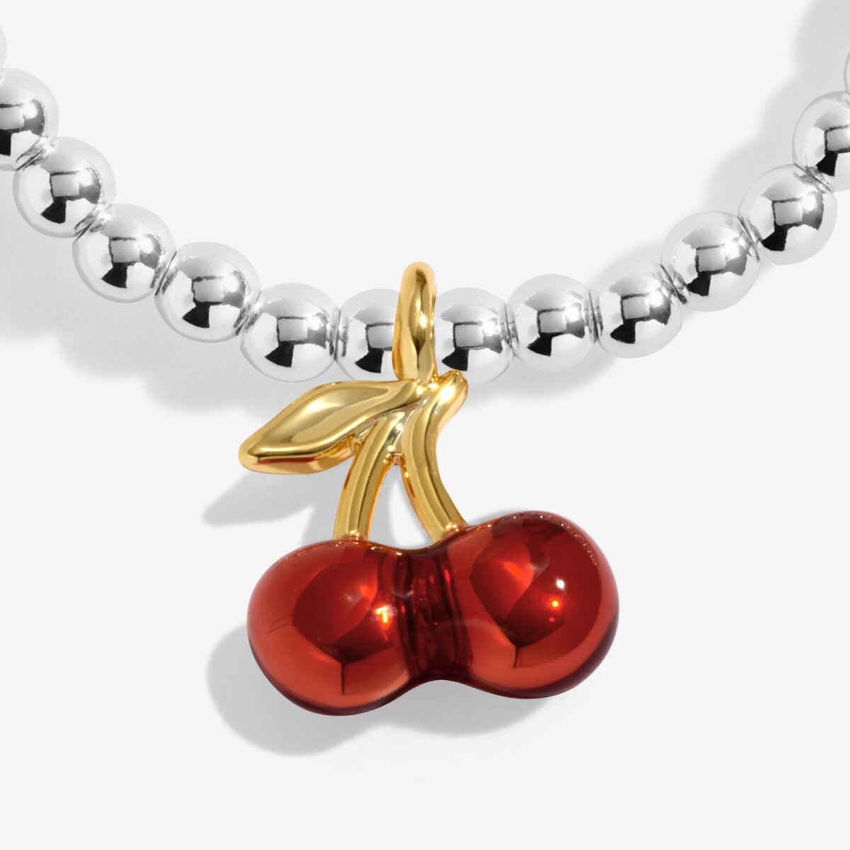 Joma jewellery stretch beaded silver plated bracelet with red cherry charm presented on a sentiment card.