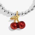 Joma jewellery stretch beaded silver plated bracelet with red cherry charm presented on a sentiment card.