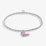 A silver beaded stretch bracelet with a heart-shaped charm featuring a colorful plaid pattern in pink, green, and purple, set against a light gray background.