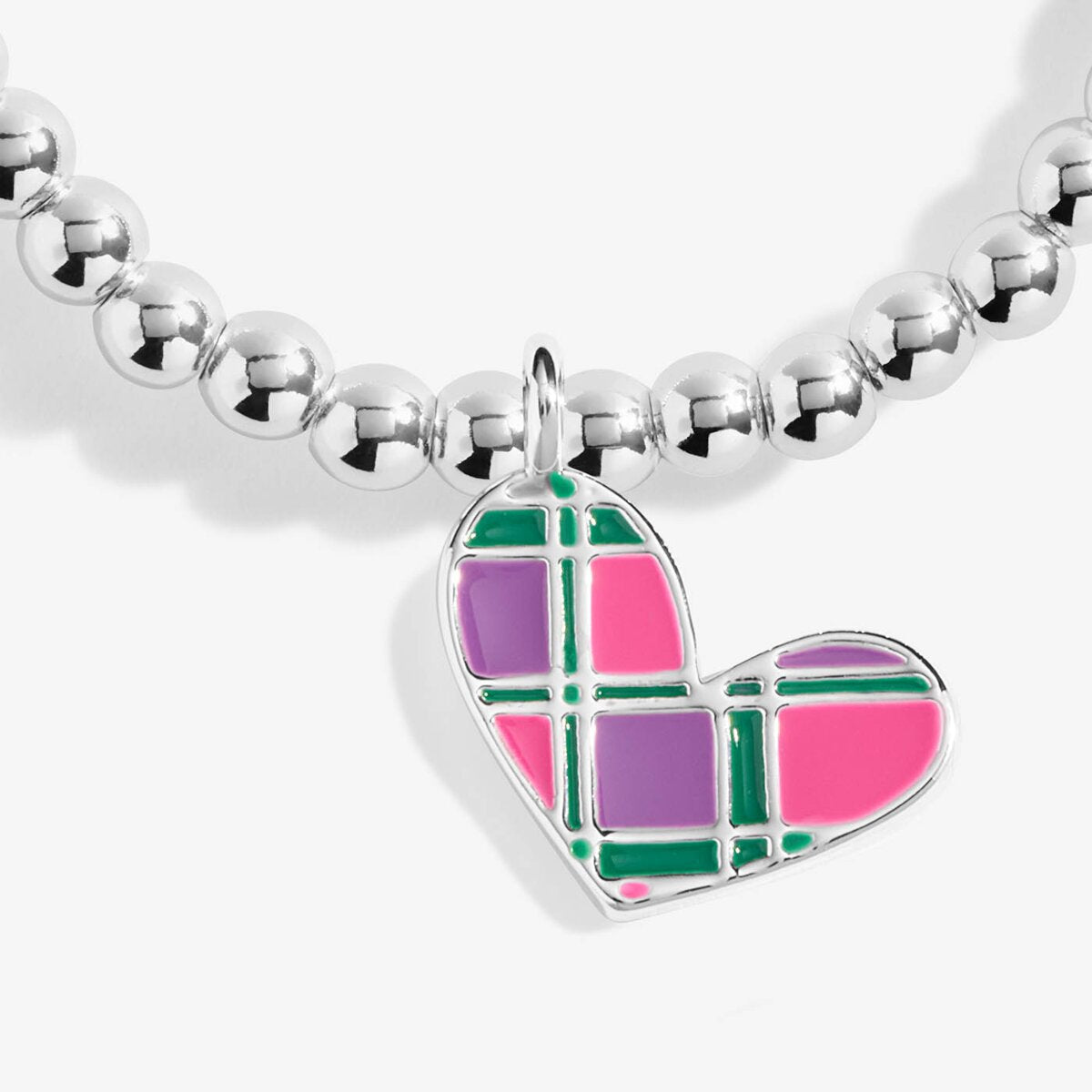A close-up of a silver beaded necklace with a heart-shaped charm featuring a pink, purple, and green plaid pattern, set against a clean white background.