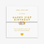 A 21st birthday bracelet by Joma Jewellery on its white retail card packaging. The bracelet features a silver chain with a central heart charm split into three colours: rose gold, yellow gold, and silver