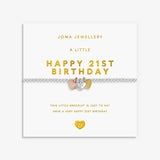 A 21st birthday bracelet by Joma Jewellery on its white retail card packaging. The bracelet features a silver chain with a central heart charm split into three colours: rose gold, yellow gold, and silver