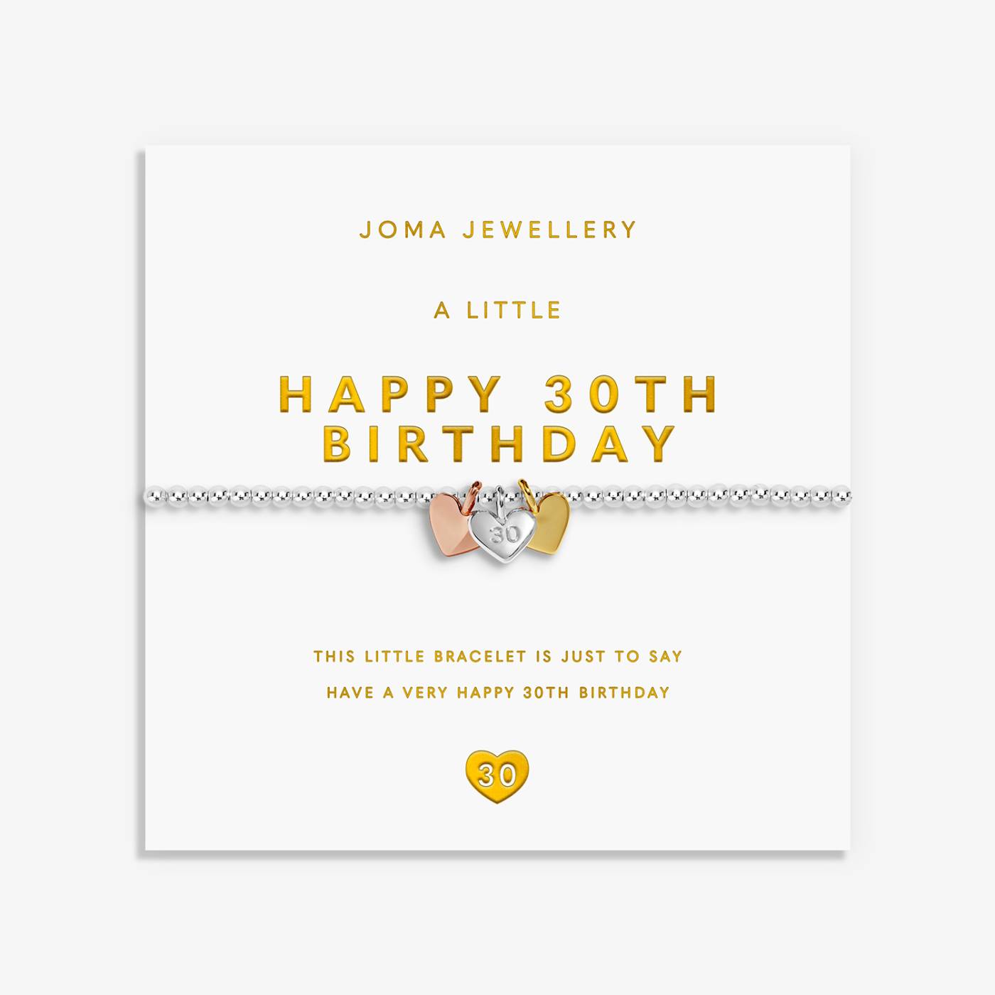 A silver bracelet with a 3 mixed metal heart charms, displayed on its white Joma Jewellery gift card with gold lettering.