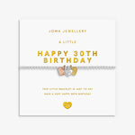 A silver bracelet with a 3 mixed metal heart charms, displayed on its white Joma Jewellery gift card with gold lettering.