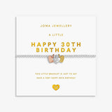 A silver bracelet with a 3 mixed metal heart charms, displayed on its white Joma Jewellery gift card with gold lettering.