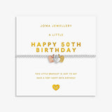 A silver bracelet with small heart-shaped charms featuring rose gold, silver and gold details, displayed on a white Joma Jewellery gift card that reads 'A LITTLE HAPPY 50TH BIRTHDAY'.