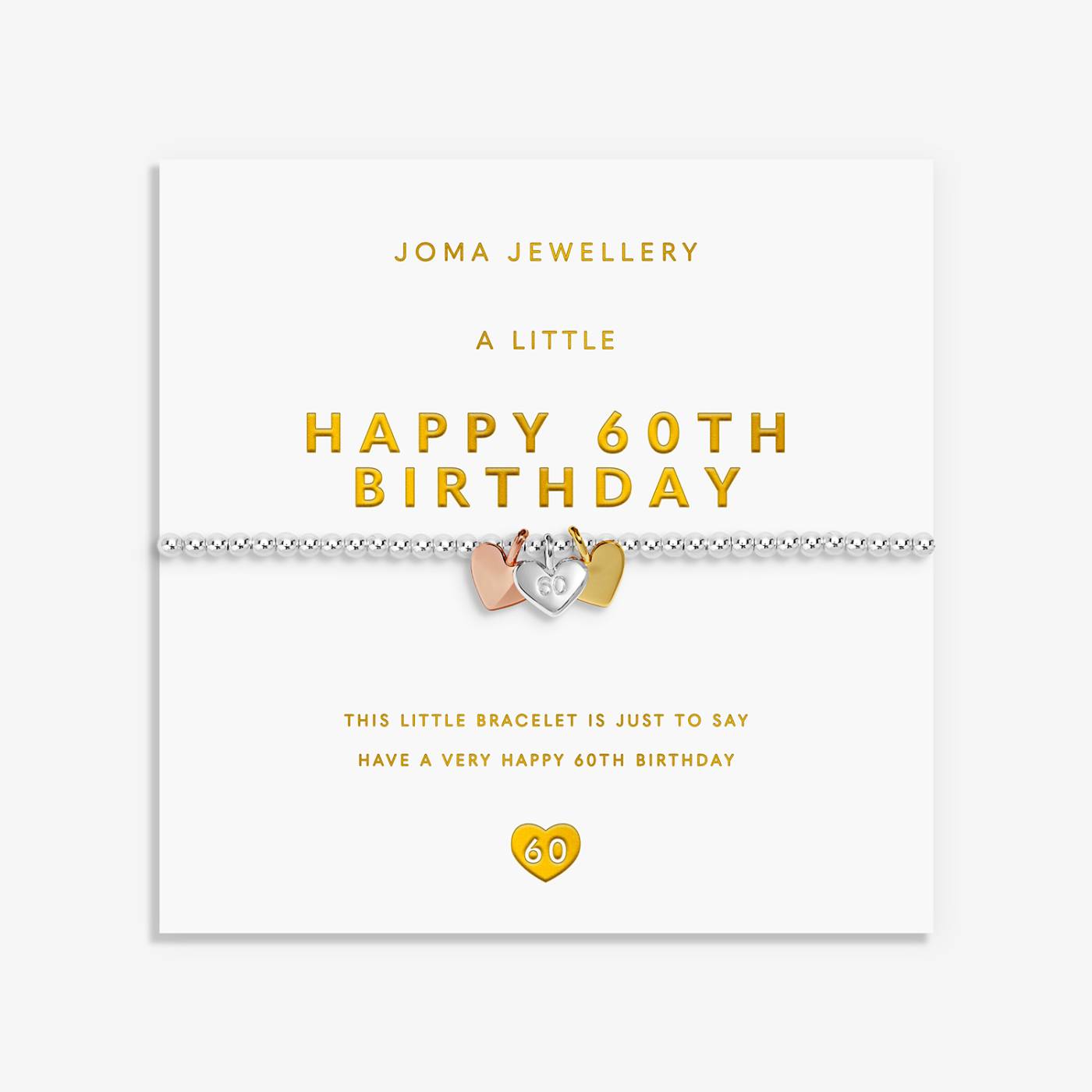 A 60th birthday bracelet by Joma Jewellery on its white gift card. The bracelet features a silver-toned chain with a central silver heart-shaped charm plus a rose gold and gold heart charm.