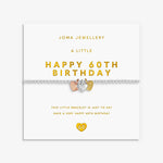 A 60th birthday bracelet by Joma Jewellery on its white gift card. The bracelet features a silver-toned chain with a central silver heart-shaped charm plus a rose gold and gold heart charm.