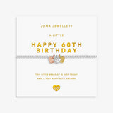 A 60th birthday bracelet by Joma Jewellery on its white gift card. The bracelet features a silver-toned chain with a central silver heart-shaped charm plus a rose gold and gold heart charm.