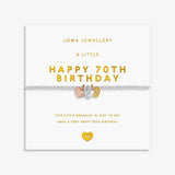 A silver 70th birthday bracelet by Joma Jewellery, featuring 3 heart charms in silver, gold and rose gold displayed on its white gift card with gold lettering.