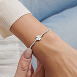 Joma Jewellery silver plated beaded bracelet with four leaf clover charm presented on a foil stamped sentiment card.