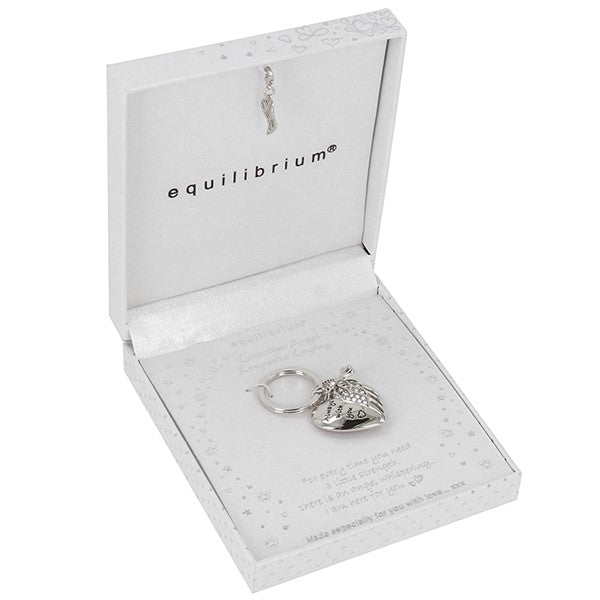 A silver angel keychain displayed inside an open white gift box with the brand name 'equilibrium' printed inside the lid.