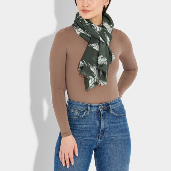 Model wearing grey scarf with winter fir design