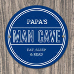 Personalised blue circular Pap's Man Cave sign with white lettering.
