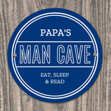 Personalised blue circular Pap's Man Cave sign with white lettering.