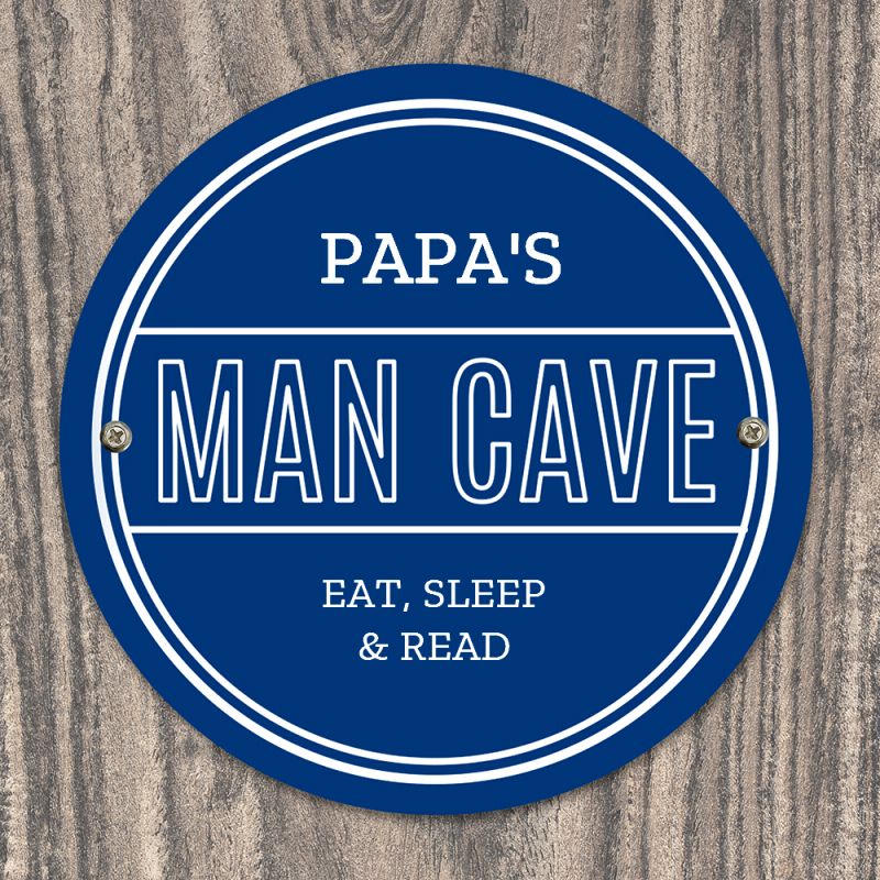 Personalised blue circular Pap's Man Cave sign with white lettering.
