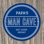 Personalised blue circular Pap's Man Cave sign with white lettering.
