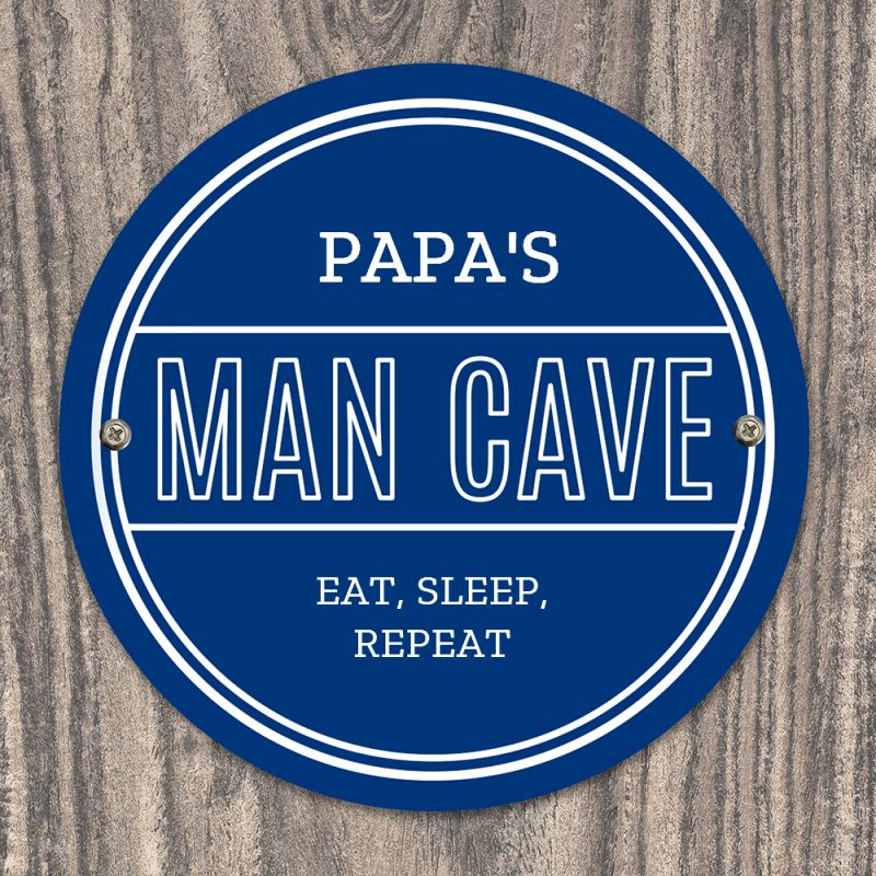 Personalised blue circular Pap's Man Cave sign with white lettering.