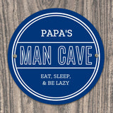 Personalised blue circular Pap's Man Cave sign with white lettering.