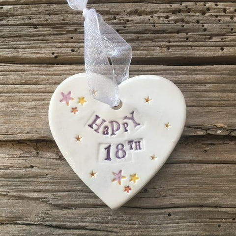 Hand painted ceramic heart featuring star design and the sentiment 'Happy 18th'  Handmade in the UK using clay, glaze and paint sourced locally.  Material:  Ceramic