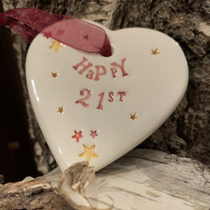Hand painted ceramic heart featuring star design and the sentiment 'Happy 21st'  Handmade in the UK using clay, glaze and paint sourced locally.  Material:  Ceramic
