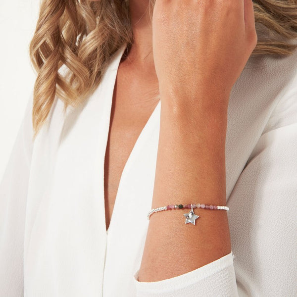 Joma Jewellery 'a little' bracelet with special tourmaline gemstones and a gently hammered silver star charm, presented on a sentiment card which reads:  'Wear this bracelet every day, because you're loving and affectionate in every way'
