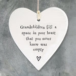 East of India hanging porcelain heart which reads:  'Grandchildren fill a space in your heart that you never knew was empty'