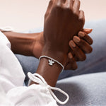 Joma Jewellery 'a little' bracelet with pretty little charm, presented on a sentiment card which reads:  'Wear this charm bracelet with all you do, and know angels are watching over you'  Beautifully packaged in it's own Joma Jewellery envelope and gifting card.