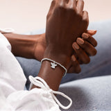 Joma Jewellery 'a little' bracelet with pretty little charm, presented on a sentiment card which reads:  'Wear this charm bracelet with all you do, and know angels are watching over you'  Beautifully packaged in it's own Joma Jewellery envelope and gifting card.